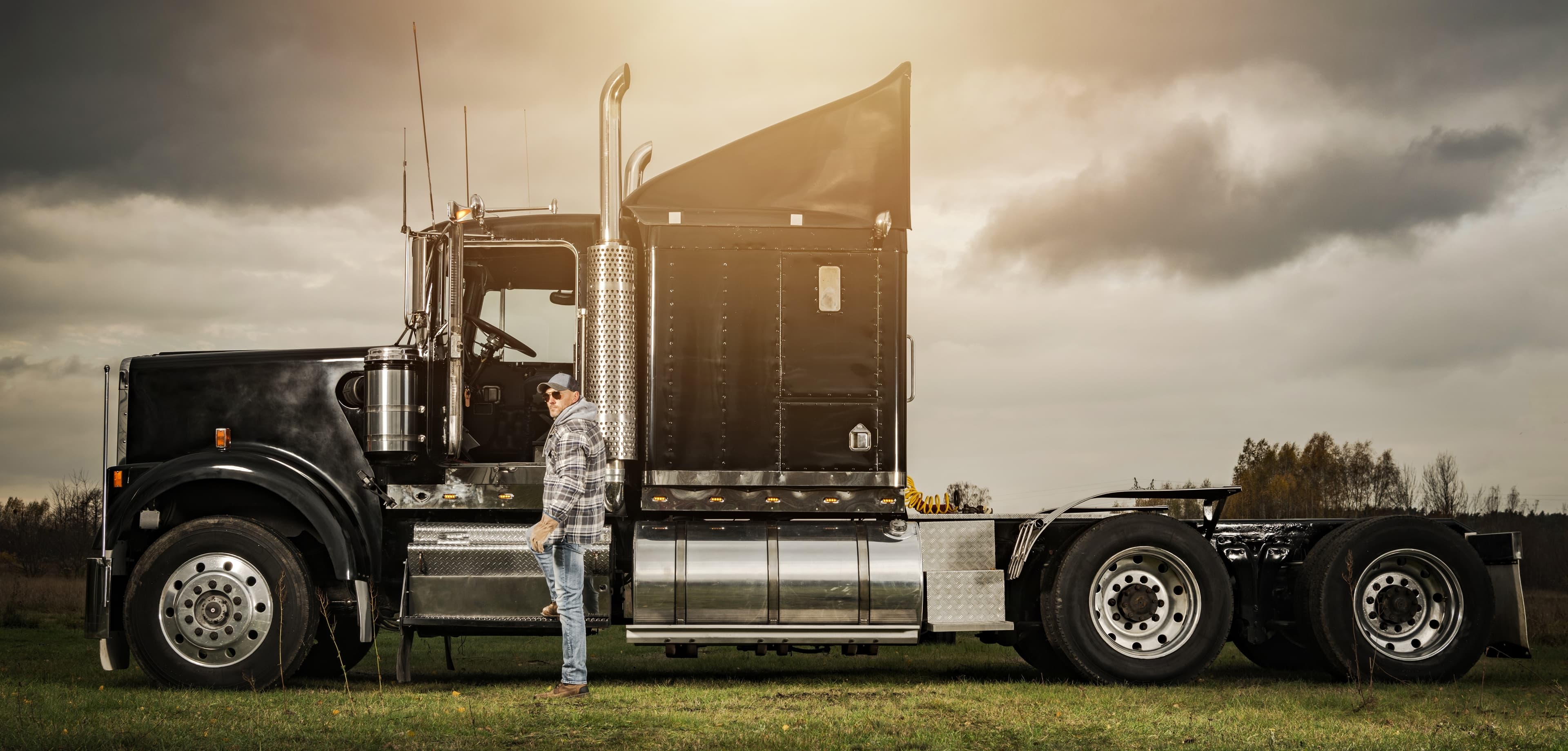 Owner-operator beside a semi-truck
